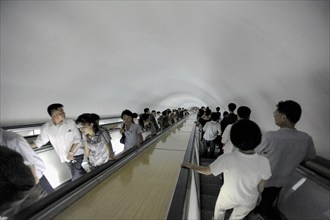 09.08.2012, Pyongyang, North Korea, Asia, Commuters on an escalator leading to an underground