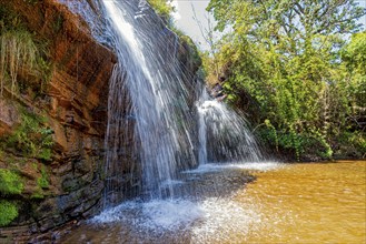 Waterfall among the rocks and forest in the Muaimii environmental reserve in the state of Minas