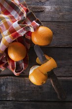 Lots of freshly picked oranges on dark table