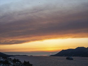 Evening atmosphere at sunset by the sea, view from the bell tower, cruise ship near Korcula,