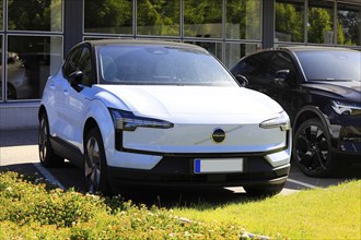 White Volvo EX30, a battery electric subcompact crossover SUV manufactured by Volvo Cars, parked