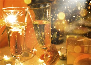 Sparklers in a glass of champagne, transparent glass with wine and splashes. New Year, festive