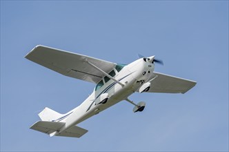 Single-engine sport airplane in a clear blue sky