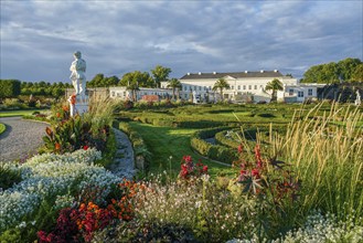 Fantastic Herrenhausen gardens of Hannover with statue and luxury colorful flowerbeds with shiny