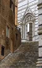 Siena, Italy, 28 November, 2022: stairs leading from the old town up to the cathedral square in