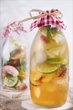 Bottle of infused fruit tea with peach and lemon