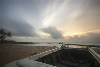 Landscape by the sea and sandy beach. A boat lies in the sand and adds a special touch to the