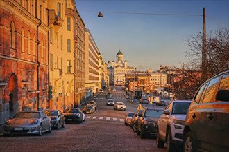 Cars and slow traffic in Eteläranta, Helsinki, Finland in the golden hour of a sunny November