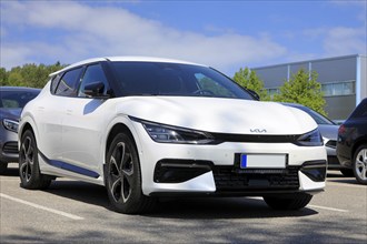 White Kia EV6 fully electric crossover car parked at the new car dealership. Salo, Finland. June