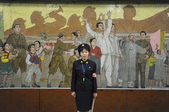 09.08.2012, Pyongyang, North Korea, Asia, A platform supervisor stands in front of a huge mosaic