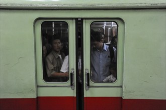 09.08.2012, Pyongyang, North Korea, Asia, Passengers stand in a full underground compartment in