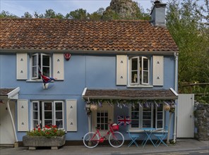 Cheddar, United Kingdom, 1 September, 2022: picturesque house in the village center with a red