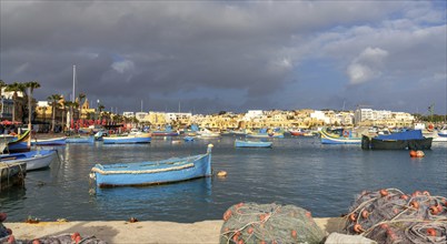 Marsaxlokk, Malta, 22 December, 2023: colorful fishing boats in the harbor of Marsaxlokk in