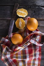 Lots of freshly picked oranges on dark table