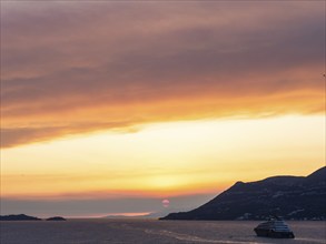 Cloudy atmosphere at sunset by the sea, view from the bell tower, cruise ship near Korcula, Korcula