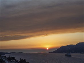 Evening atmosphere at sunset by the sea, view from the bell tower, cruise ship near Korcula,