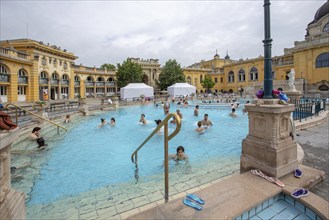 04-26-2014. Budapest, Hungary. People outdoors in pool of Szechenyi Thermal Baths, 1909 year of