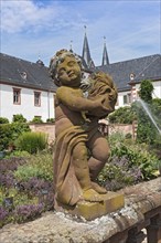 Figure sculpture statue in the monastery garden of St. Marcellinus and Peter in Seligenstadt,