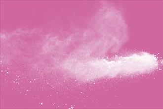 White powder explosion on pink background