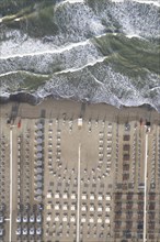 Aerial view of Versilia beach with rough sea photographed from above