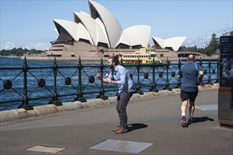 25.09.2019, Sydney, New South Wales, Australia, A man holds an ice cream in his hand and takes a