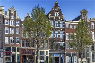 Historical houses on embankment in Amsterdam, Netherlands