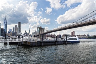 New York City, USA, June 24, 2018: Pier in East River Against Cityscape of Downtown of Manhattan