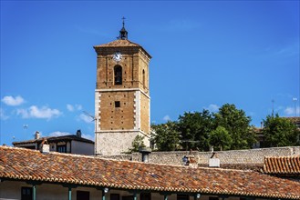 View of Clock Tower of Chinchon in Madrid. Low angle view agaisnt sky. Old Our Lady of Grace church