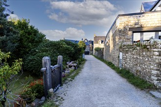 Picturesque narrow street of the medieval village of Locronan a sunny day of summer at evening