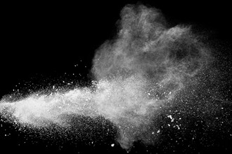 Bizarre forms of white powder explosion cloud against black background.White dust particles splash