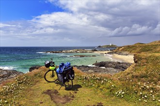 E-bike on the South West Coast Path, coastline with Godrevy Island and lighthouse, landscape