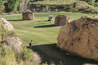 Golden, Colorado, The Fossil Trace Golf Course. Golfers play near footprints of dinosaurs and