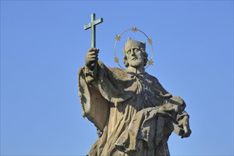 Sculpture Saint John Nepomuk holding up cross in hand, arm, figure, detail, halo, Old Main Bridge,