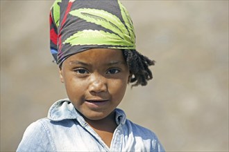 Close up portrait of Creole girl wearing headscarf on the island of Santiago, Cape Verde, Cabo