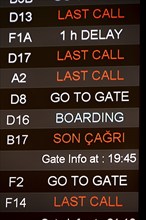 Last call, check-in, departure board with departure schedule in different languages, gates at