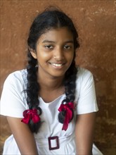 Sinhalese schoolgirl with white clothes, black braids and red ribbons, Sri Lanka, Asia