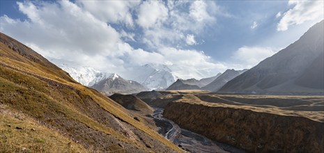 Valley with river Achik Tash between high mountains, mountain landscape with glaciated peak Pik