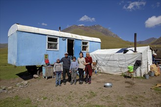 Shepherd family in front of their caravan on their summer pasture, West Karakol Valley, Tien Shan