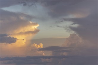 Formation of clouds (cumulus) formed by pink and orange clouds at dusk. Cevennes, France, Europe