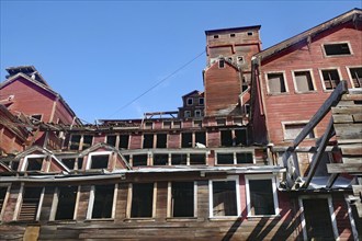 Old industrial ruins on the hillside, copper mining, red wooden buildings, ghost town, Unesco World