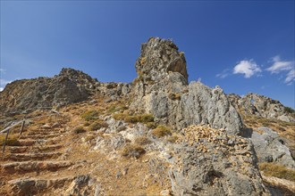 Stone steps, rocky crags, cave, blue sky, white clouds, Kapsa, Orthodox Monastery, East Crete,