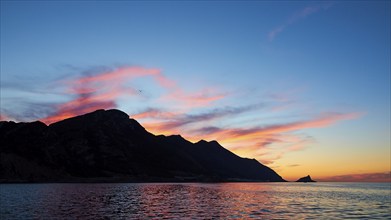 Blue evening sky, pink illuminated clouds, rocky coast, sunset, dusk, Marettimo, Egadi Islands,