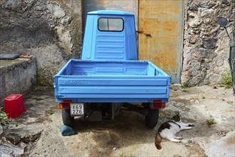 Ape, motorised tricycle, light blue, from behind, yard, Rinella, town on the south coast, Salina,