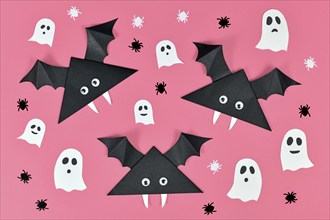 Black paper vampire bats with funny googly eyes and and ghosts and spider shaped confetti on pink