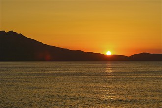 Sunset, sun ball over Gramvoussa peninsula, sun reflection on the sea, orange sky, Rodopou