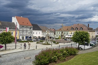 Town hall square with storm clouds and sgraffito house, Weitra, Lower Austria, Austria, Europe