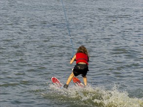 Child water skiing lake, leisure and water sports, Germany, Europe