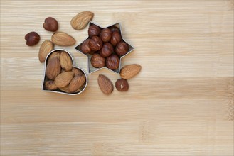 Nuts and cookie cutters, almonds and hazelnuts