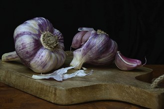 Fresh red garlic on chopping board, France, Europe