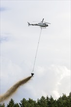 Symbolic image, climate change, helicopter, helicopter spreading finely painted limestone and wood